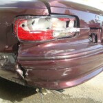 Before and after photographs of a damaged Chevy Impala that was repaired by Elite Paint & Body Shop in West Palm Beach, Florida.